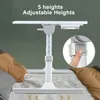 A white adjustable laptop table is shown set up on a bed with pillows. Produktbild-Vorschau