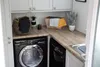 A laundry room with appliances and cabinets. Produktbild-Vorschau