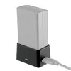 A battery charger with a battery inserted, plugged into a USB cable. Podgląd zdjęcia produktu