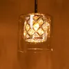 A close-up shot of a pendant light with a glass shade and crystal accents. Podgląd zdjęcia produktu