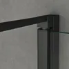 A close-up view of a black metal frame and clear glass panel of a shower enclosure against a textured gray wall. Voir les images du produit