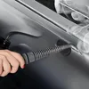 A hand holding a steam cleaner nozzle, directing steam onto a car's surface. Náhled obrázku produktu