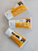 Three tubes of cream are arranged diagonally on a light-colored surface. Anteprima dell’immagine prodotto