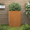 A tall, rectangular corten steel planter with a green bush inside, placed on a lawn in front of a wooden fence. Produktbild-Vorschau