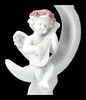 A white cherub figurine playing a lute while sitting on a crescent moon. Produktbild-Vorschau