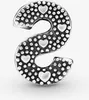 A silver letter 'S' charm with small hearts and dots. Produktbild-Vorschau