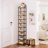 A multi-tiered shoe rack filled with shoes, placed next to a white door in an entryway. A pegboard with keys and small decorative items is on the wall behind it, and a sofa is visible in the background. Produktbild-Vorschau