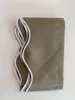 A folded tan fabric awning valance with white elastic trim is shown on a white background. Produktbild-Vorschau