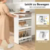 A person is pushing a narrow kitchen cart with four shelves in a kitchen setting. The cart has a wooden top and white shelves. There are inset images showing the wheels of the cart. Podgląd zdjęcia produktu