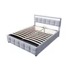 A grey upholstered bed frame with a slatted mattress base, shown from a diagonal angle against a white background. Voir les images du produit