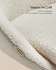 Close-up of a chair with a soft, textured fabric and a brand tag. Produktbild-Vorschau