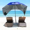 A beach scene with two lounge chairs under a beach umbrella. Voir les images du produit