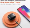 A black charging case for wireless earbuds is placed on an orange circular stand, next to a smartphone that is charging. Produktbild-Vorschau