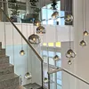A modern staircase with glass railings and a series of hanging pendant lights. Produktbild-Vorschau