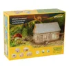 The image shows the packaging of a wooden construction set for building a model house, with a miniature house and a snail on a mossy hill depicted on the box. Anteprima dell’immagine prodotto
