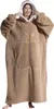 A woman wearing a large, hooded blanket with an apple design. Produktbild-Vorschau