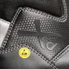 A close-up view of a black safety boot, showing the brand logo and an ESD symbol. Produktbild-Vorschau
