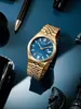 A gold Citizen watch with a blue face is displayed on a blue surface, surrounded by other objects like a pen and chess pieces. Podgląd zdjęcia produktu