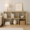 A wooden cube shelf unit with books, a vase, a bowl, and a basket. Produktbild-Vorschau