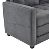 Close-up view of the armrest and side of a gray sofa. Produktbild-Vorschau