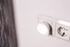 A close-up of a night light plugged into a wall socket. Anteprima dell’immagine prodotto