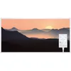 A digital panel heater with a landscape image of a sunset over mountains. Produktbild-Vorschau