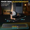 A man is performing a side plank exercise on a black gym mat in a fitness studio. The mat has dimensions indicated by text and lines. Produktbild-Vorschau