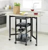 A kitchen cart with a drop-leaf top, set up in a kitchen environment with food and drinks on top. Produktbild-Vorschau