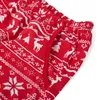 A close-up view of red pajama pants with a white Christmas-themed pattern. Produktbild-Vorschau