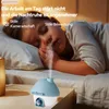 A child sleeping in bed with a humidifier emitting mist. Produktbild-Vorschau
