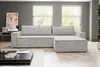 A modern living room with a light gray sectional sofa, coffee table, and artwork on the wall. Produktbild-Vorschau
