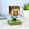A Minecraft Steve figurine is displayed on a desk next to a laptop and a potted plant. Produktbild-Vorschau