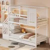A white bunk bed with a house-like frame, set up in a child's bedroom with bedding and a stuffed animal. Náhled obrázku produktu