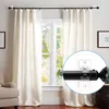 A close-up view of a curtain rod bracket attached to a wall, with a curtain rod and curtain visible in the background. Produktbild-Vorschau