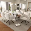 A dining room scene with a white rectangular extendable dining table and six beige upholstered chairs. Anteprima dell’immagine prodotto
