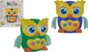 A toy owl and its packaging are displayed against a white background. Produktbild-Vorschau