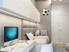 A modern bedroom with a desk, bed, and a soccer ball clock. Produktbild-Vorschau