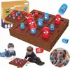 A collage of images showing a wooden tic-tac-toe game with cartoonish pieces, children playing the game, and a family playing the game. Náhled obrázku produktu