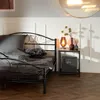 A bedroom scene with a bed and a nightstand. Náhled obrázku produktu