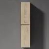 A tall, narrow cabinet with a wood grain finish is mounted on a gray wall, casting a shadow. Produktbild-Vorschau