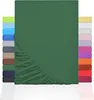 A dark green fitted sheet is displayed prominently, with a stack of other colored fitted sheets visible on the left and right sides of the image. Produktbild-Vorschau