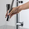A hand is holding a faucet sprayer, with water spraying out. Podgląd zdjęcia produktu