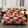 A neatly made bed with a patchwork quilt and pillows, set against a headboard and bedside tables. Anteprima dell’immagine prodotto