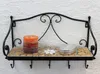 A black metal shelf with mosaic tile surface, holding a candle and a silver tin. Podgląd zdjęcia produktu