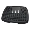 A black wireless keyboard with a touchpad and various buttons is shown from a slightly elevated front-facing angle against a white background. Produktbild-Vorschau