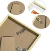 Close-up view of the back of a picture frame, showing the mounting hardware and stand. Produktbild-Vorschau