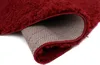 A close-up view of a dark red rug, showing the texture of the pile and the underside of the rug. Anteprima dell’immagine prodotto