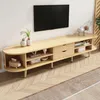 A light wood TV stand with a television mounted on the wall above it. Podgląd zdjęcia produktu