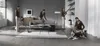 A woman is shown using a vacuum cleaner in a modern living room, with multiple instances of her cleaning in different areas. A dog is also present in the scene. Produktbild-Vorschau