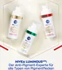 Three bottles of NIVEA Cellular Luminous630 serum are arranged in a triangular formation on a light gold and white background with decorative gold lines. Náhled obrázku produktu